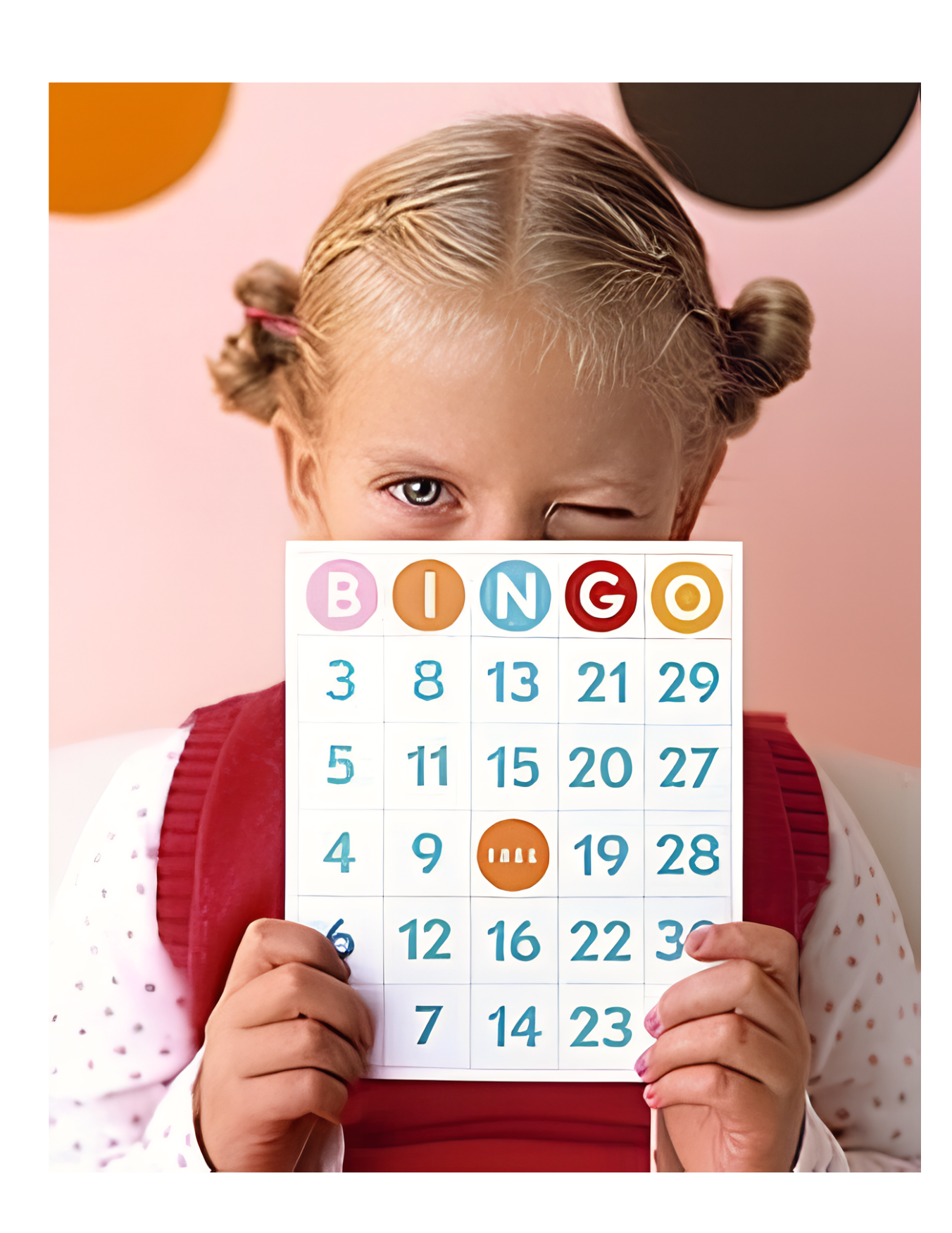 Child holding a card for BINGO