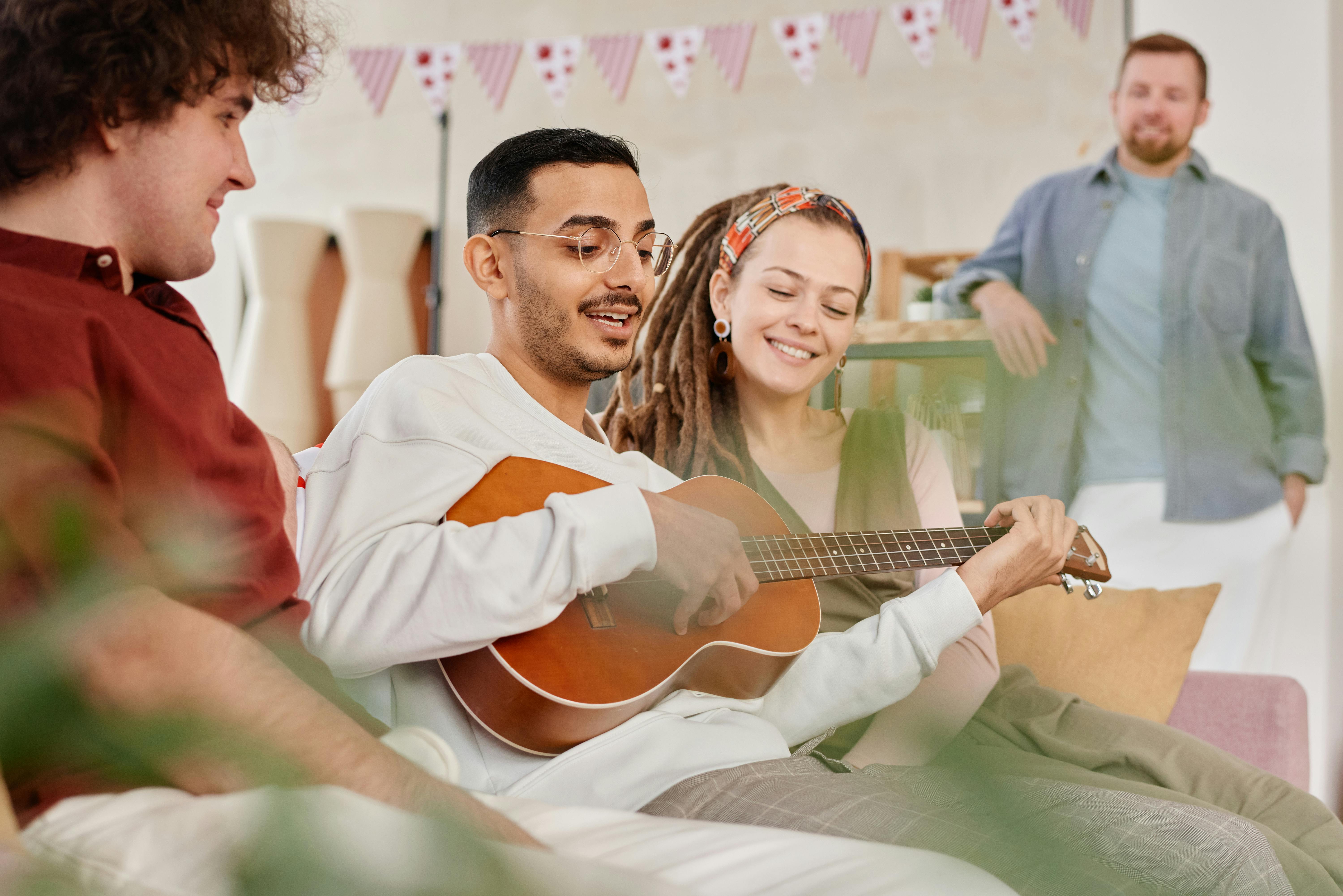 A Man Playing Ukulele for a Group