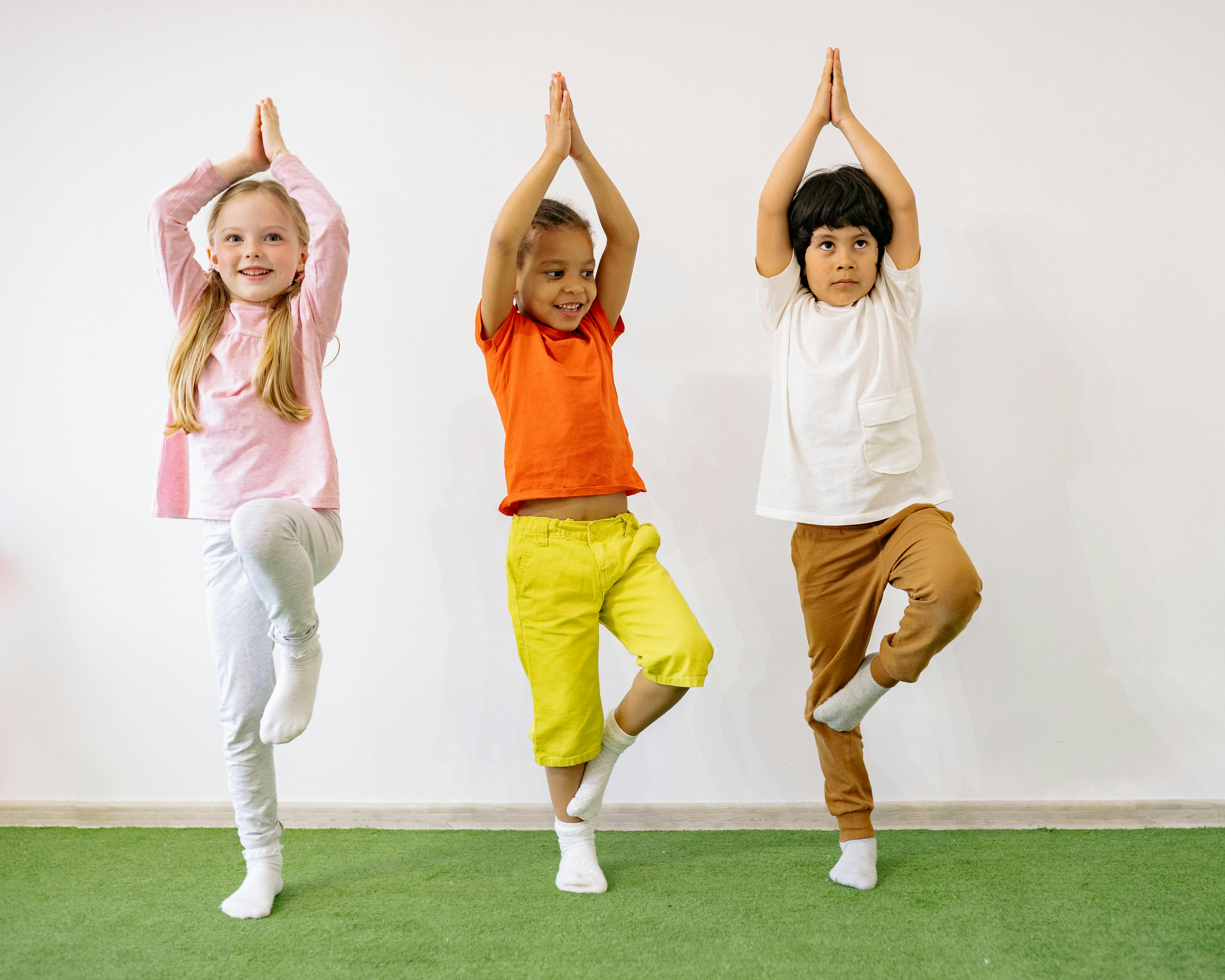 3 kids doing a yoga pose