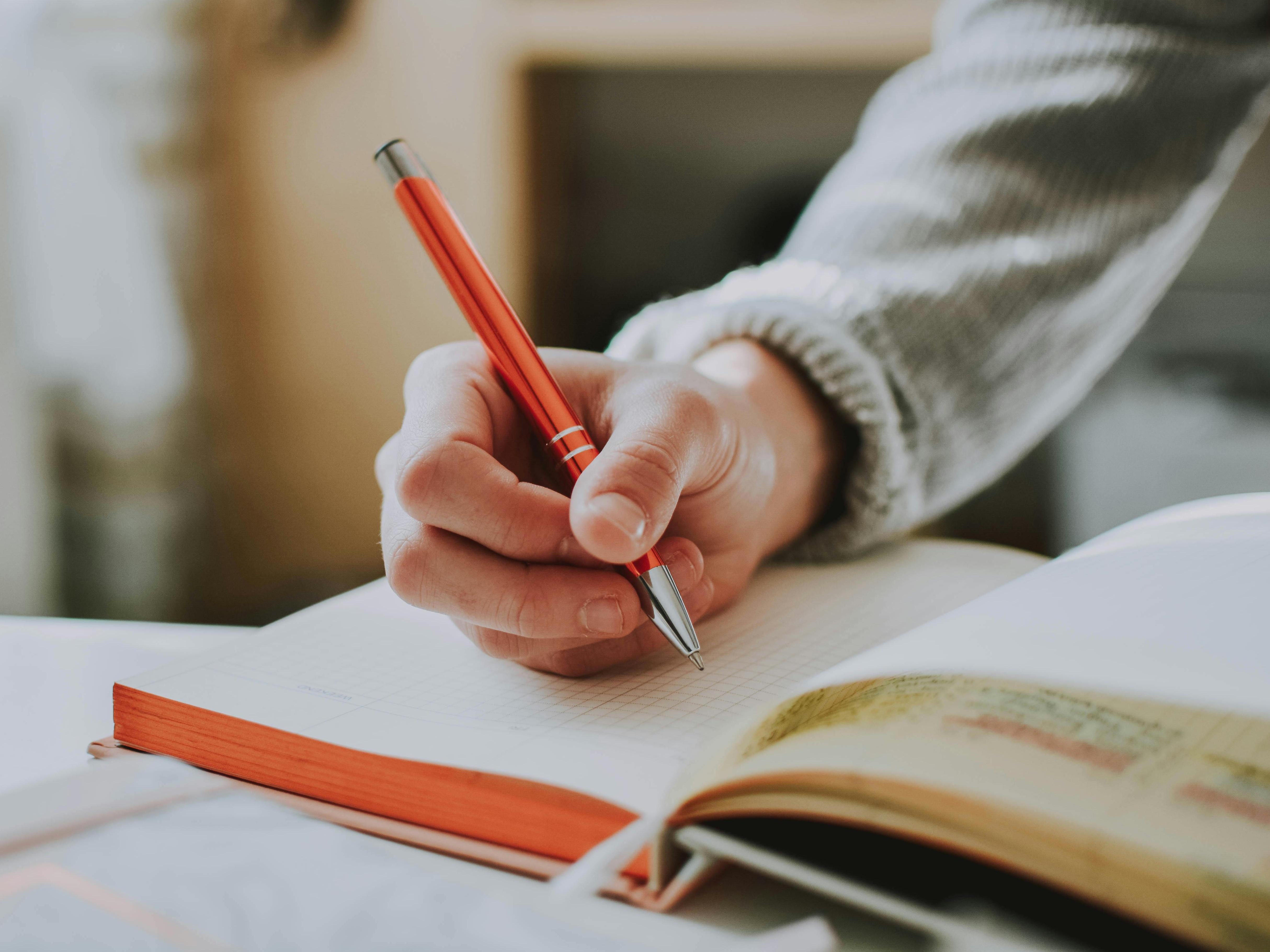 A Person Writing in a Journal