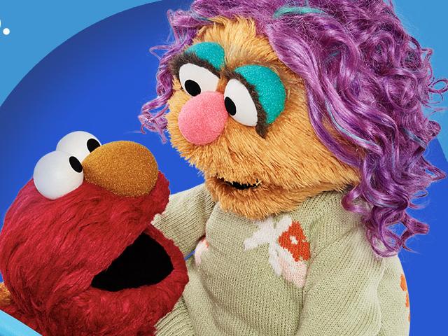 Elmo and a puppet from the show Sesame Street