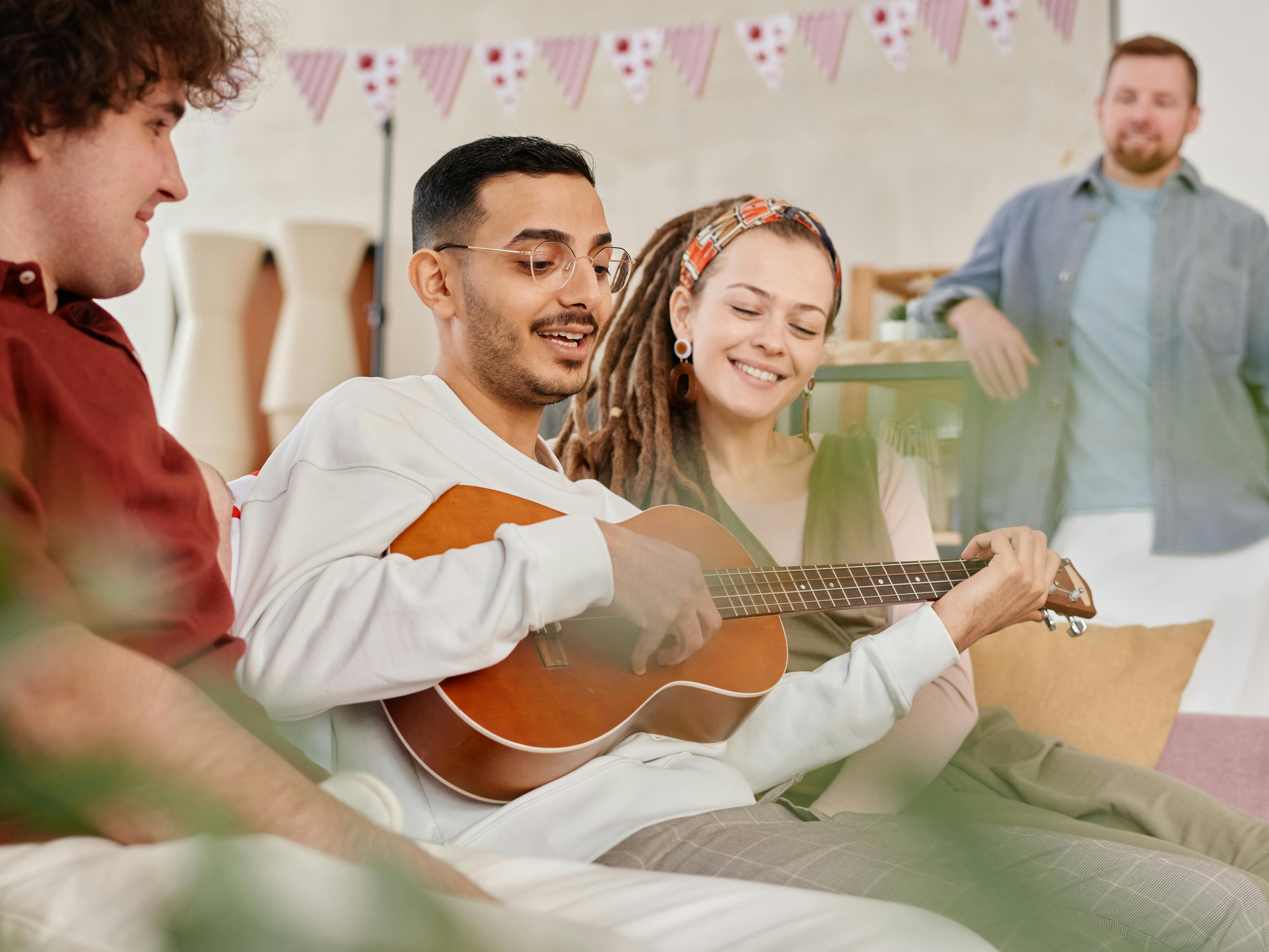 A Man Playing Ukulele for a Group