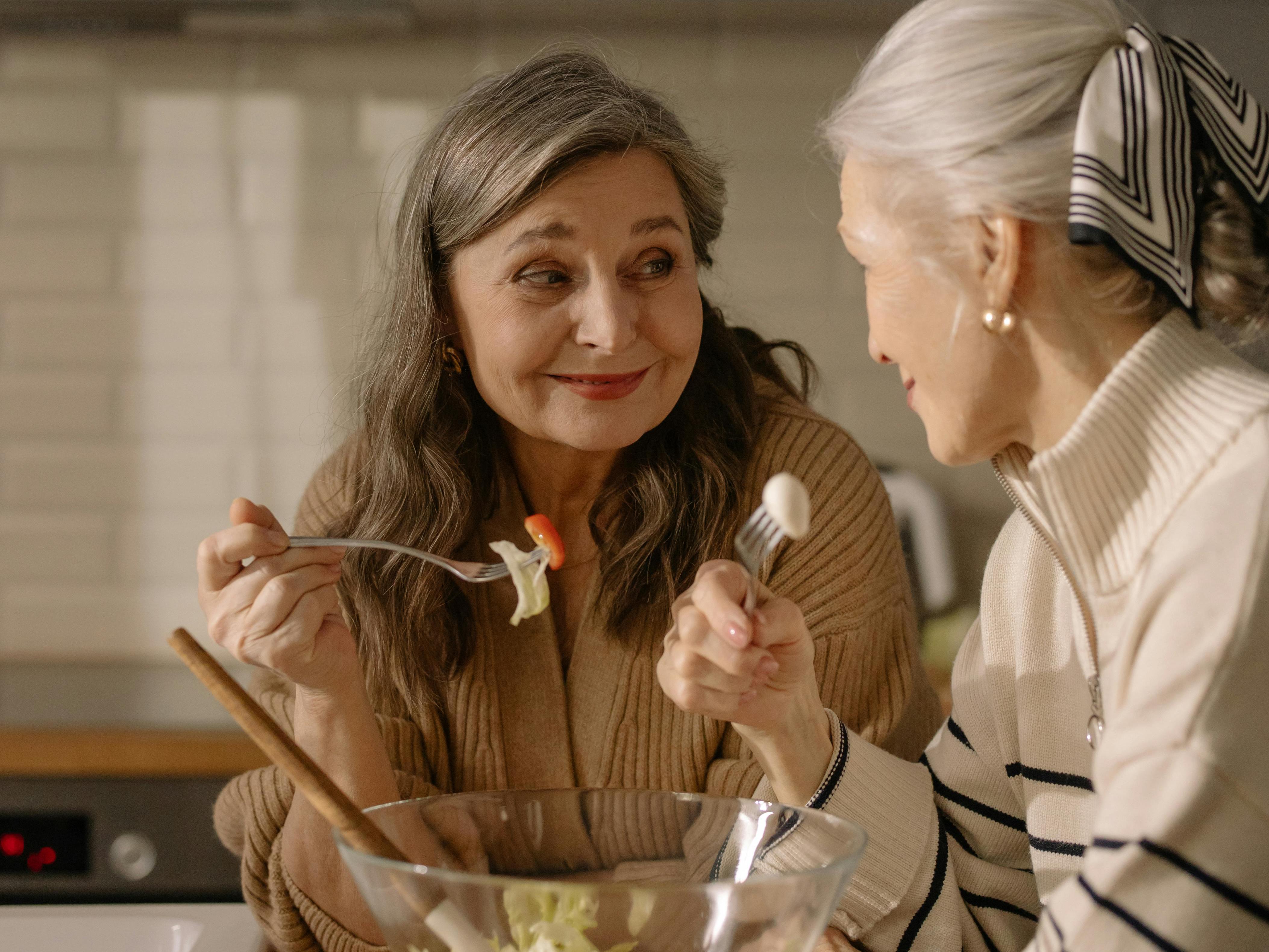 Two 60+ Women Eating Salad