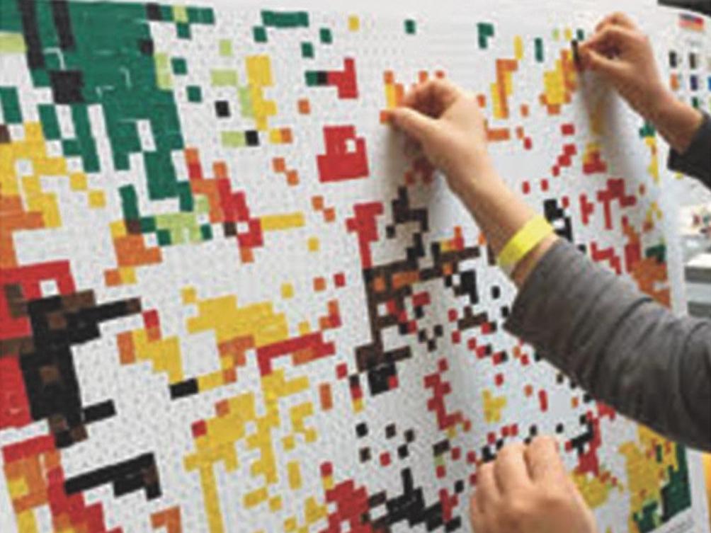 hands putting stickers on board